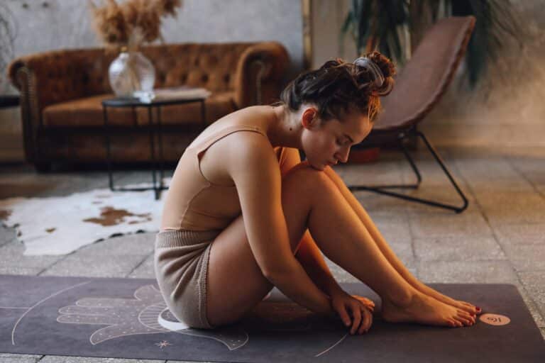 woman stretching on a yoga mat on the floor
