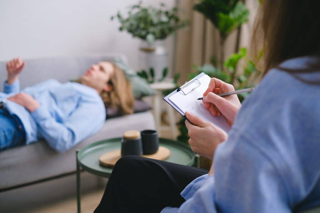 person on a couch talking about their mental health with a professional